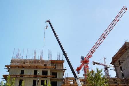 Construction of an apartment building. Cranes on a construction siteの写真素材