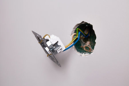 A close-up view of an electrical outlet being installed into a wall.