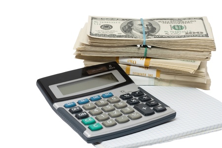 a bundle of money and a calculator on a white backgroundの写真素材