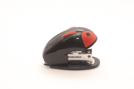 small stapler black with red on a white backgroundの写真素材