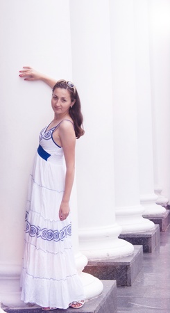 Beautiful girl in a long white columns near the Sarafan photographyの写真素材