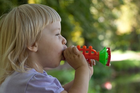 Little girl blow bubbles in the park