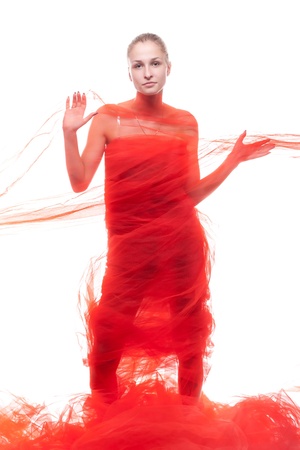 Beautiful girl in a red cloth studio shootingの写真素材