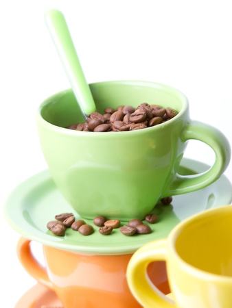 The green cup with a spoon full of coffee beansの写真素材