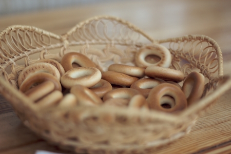 Wicker basket with bread-rings on the tableの写真素材