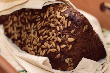 Black bread with sunflower seeds wrapped in a towel