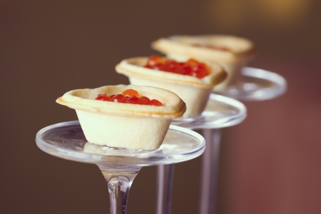 Tartlets with heart-shaped eggs on a glass baseの写真素材