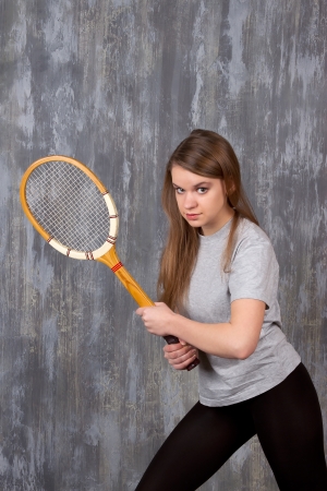 Action portrait of a girl with tennis racketの写真素材