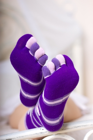 Female legs in purple socks with individual toesの写真素材