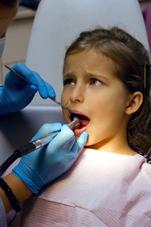 frightened girl on reception at the dentistの写真素材