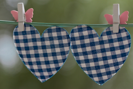 blue heart attached to a clothesline with pinの写真素材