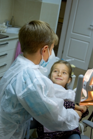 A couple of kids playing doctor at the dentistの写真素材
