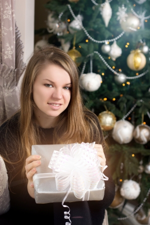 girl near Christmas tree homeの写真素材