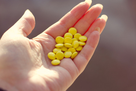 The young a hand full of pillsの写真素材