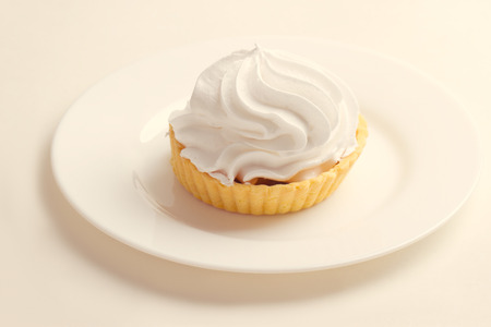 Cake with whipped cream on a plateの写真素材