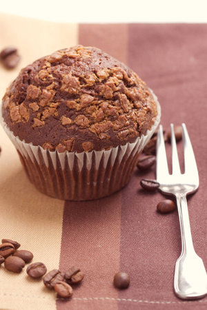 Chocolate muffins and coffee beans on the tableの写真素材
