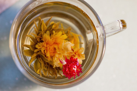 exotic green tea with flowers in glass cupの写真素材