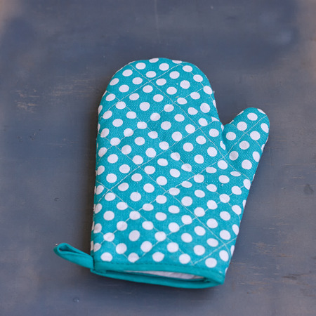 Oven mitt or potholder on the wooden background.の写真素材
