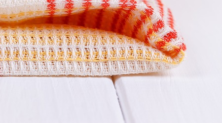 red folded tablecloth over white wooden tableの写真素材