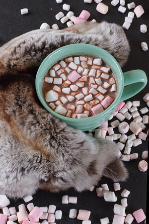 Hot chocolate with marshmallows and fur around.の写真素材