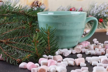 mug with hot chocolate and burning lantern on wooden tableの写真素材