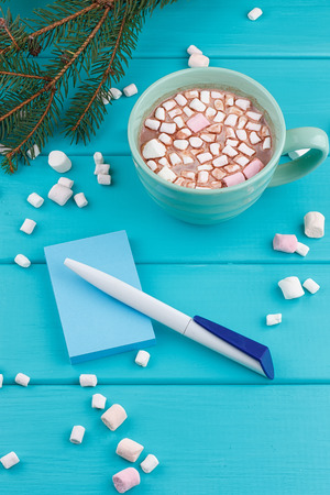 hot cocoa with marshmallows with pen and notepadの写真素材
