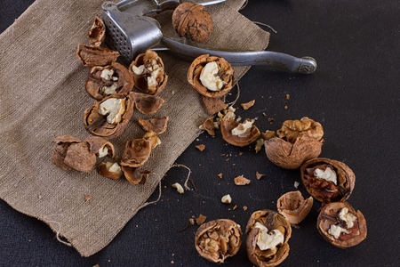 walnuts and a nutcracker on a table covered with burlapの写真素材