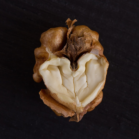 walnut in a heart isolated on black backgroundの写真素材