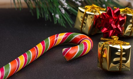 Christmas gift, tree branch and decorations on dark slate background. Christmas present background.の写真素材