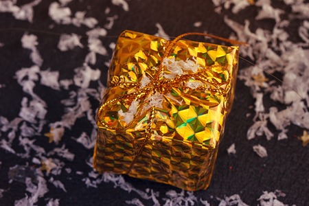 Gold box with gifts. On black backgroundの写真素材