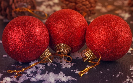 red satin Christmas balls on black backgroundの写真素材