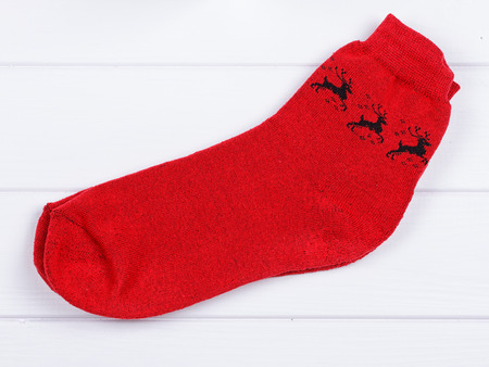 Christmas red socks on a white wooden backgroundの写真素材