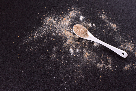 White whole-wheat flour and a spoonの写真素材