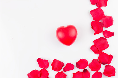 Heart and frame of artificial rose petals on white backgroundの写真素材