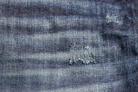 the blue Jeans torn denim texture with holeの写真素材