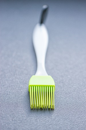 green silicone pastry brush on the blue backgroundの写真素材