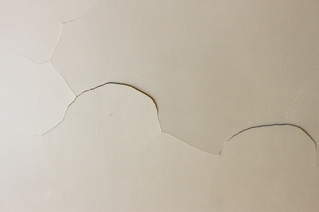 Closeup on a crack in a white ceiling of a generic, unidentified old houseの写真素材