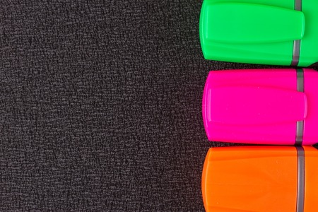 the Colored markers on a black backgroundの写真素材