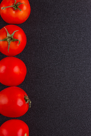 red tomatoes on black background. top viewの写真素材