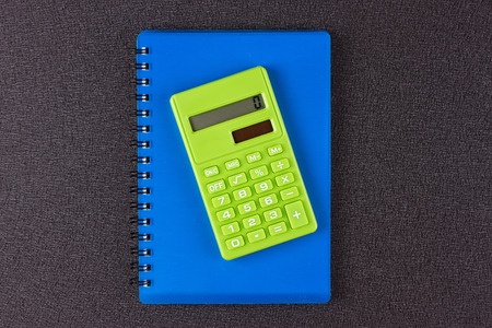 notebook and calculator on a black backgroundの写真素材