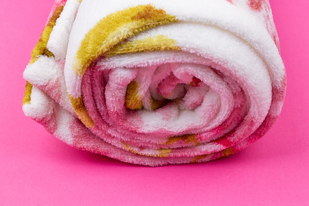 Roll of plaid. Coiled plaid on the pink backgroundの写真素材