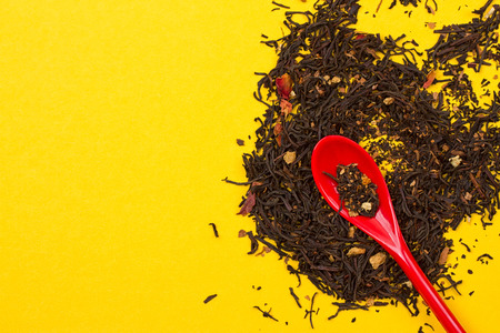 Tea composition with spoon on yellow backgroundの写真素材