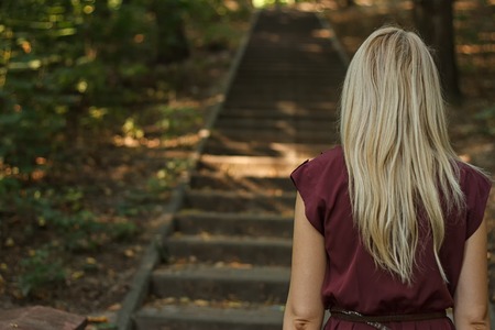 woman going up the stairs in the parkの写真素材