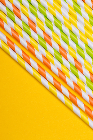 close-up colorful fancy drinking straws, fancy tube for party on the yellow backgroundの写真素材