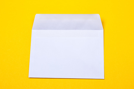 white open envelopes on the yellow backgroundの写真素材
