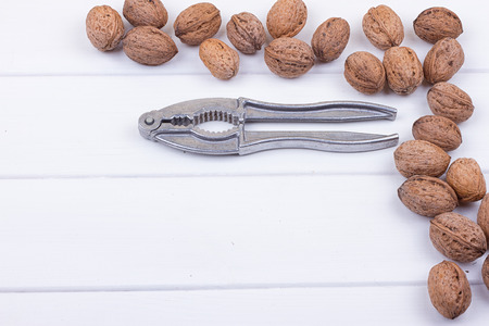 many walnuts on the white wooden background with copy-spaceの写真素材