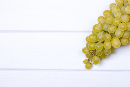 White grapes on white wooden surface. top view. copy-spaceの写真素材