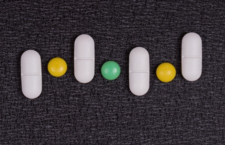 close up white pills on black background.の写真素材