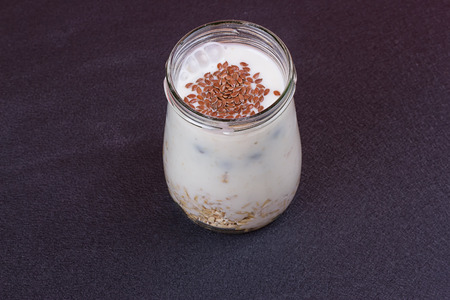 Healthy breakfast - yogurt with blueberries and muesli served in glass jar, Lazy oatmealの写真素材