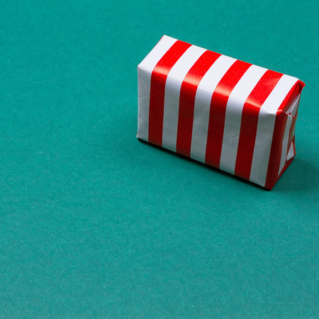 Christmas gift box on green background. Top view with copy spaceの写真素材